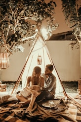 couple sitting inside tepee hut with lights onlyfans