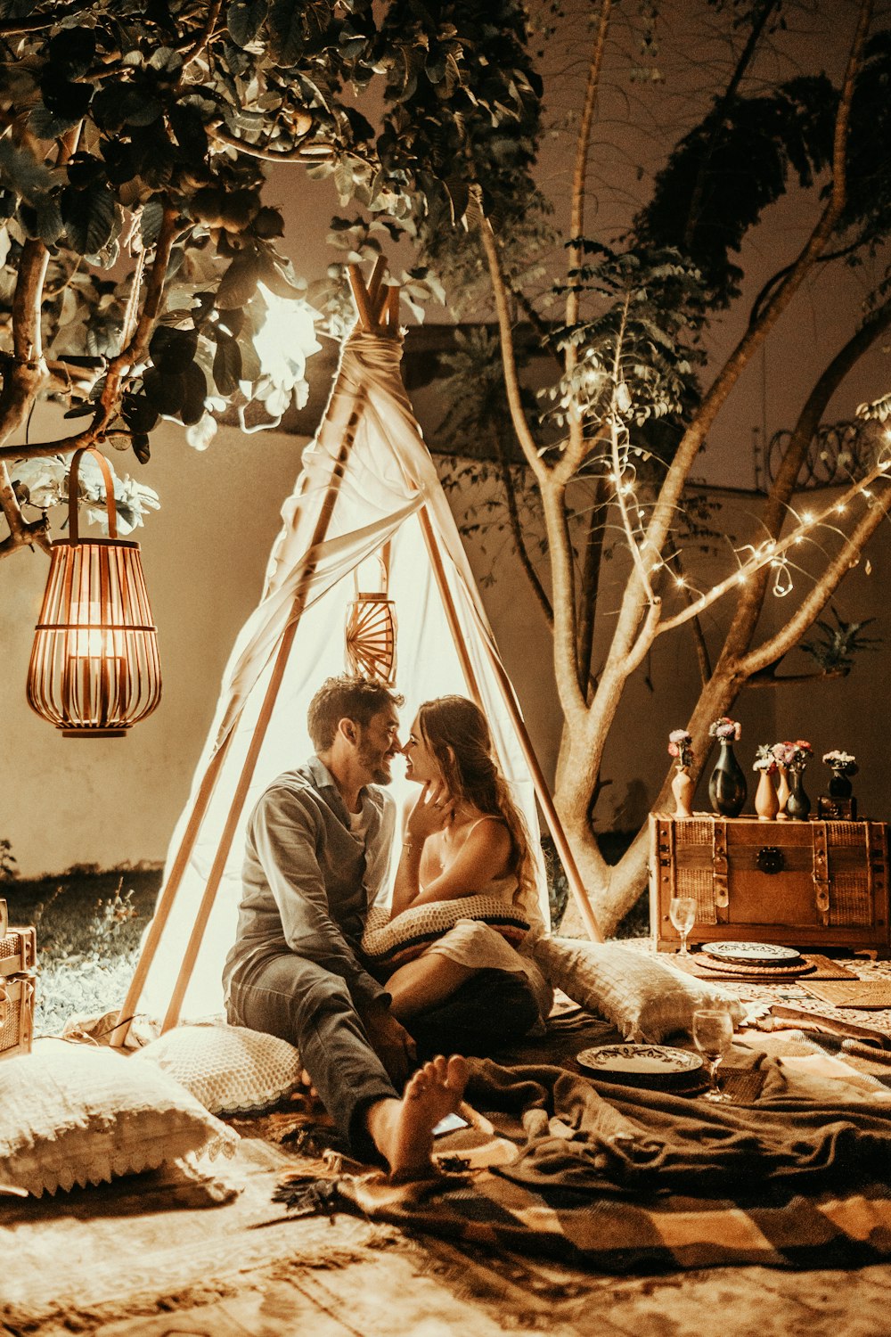 Homme et femme souriants à l’intérieur de la tente tipi