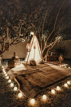 white and brown tipi tent beside trees