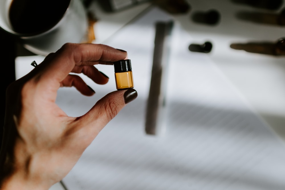 woman holds small oil bottle