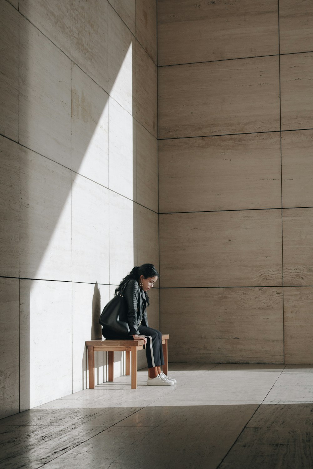 woman sitting alone behind walls