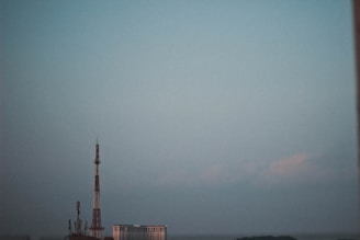 View of a modern communication tower against a clear sky.