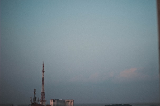 View of a modern communication tower against a clear sky.