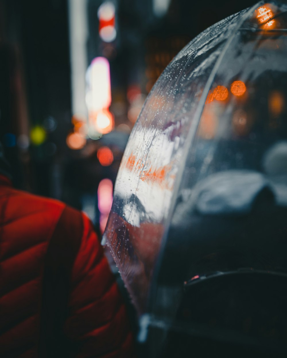 a person holding an umbrella on a city street