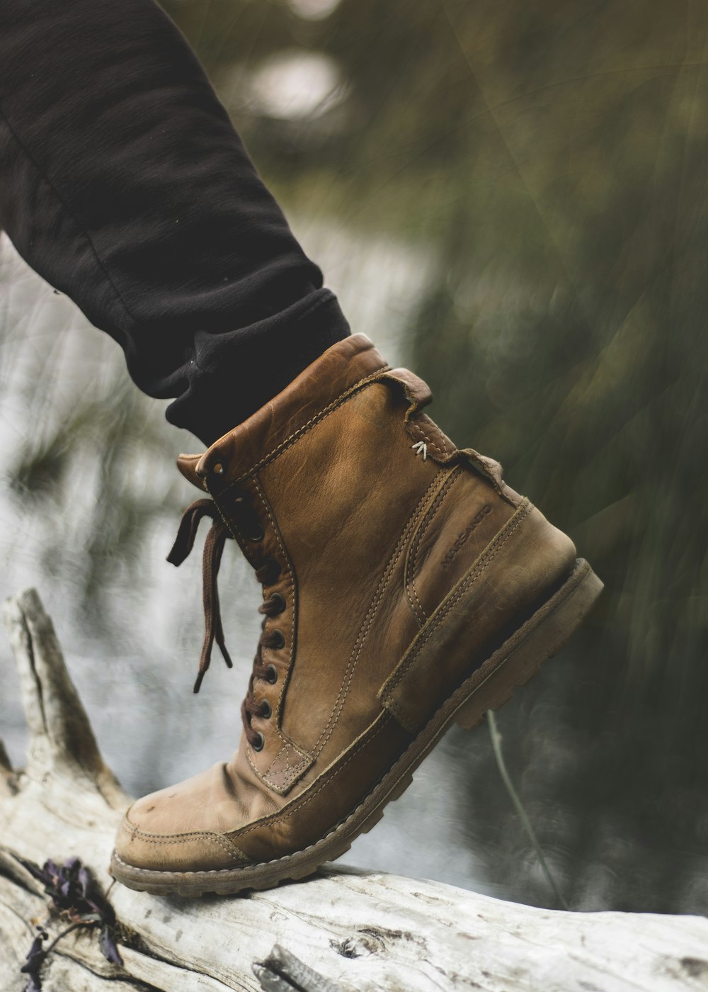 person wearing brown work boot