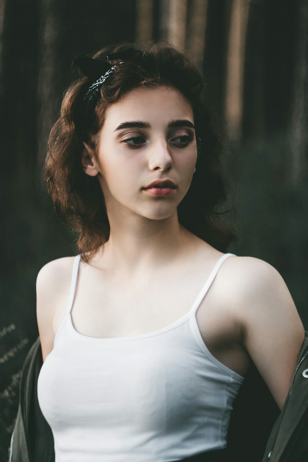 shallow focus photo of woman in white spaghetti strap top