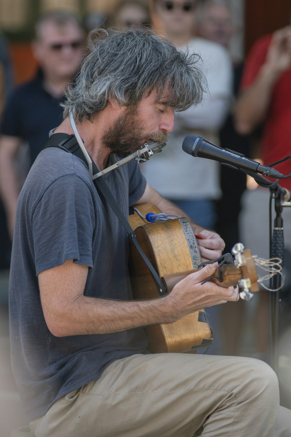 man playing acoustic guitar during day time