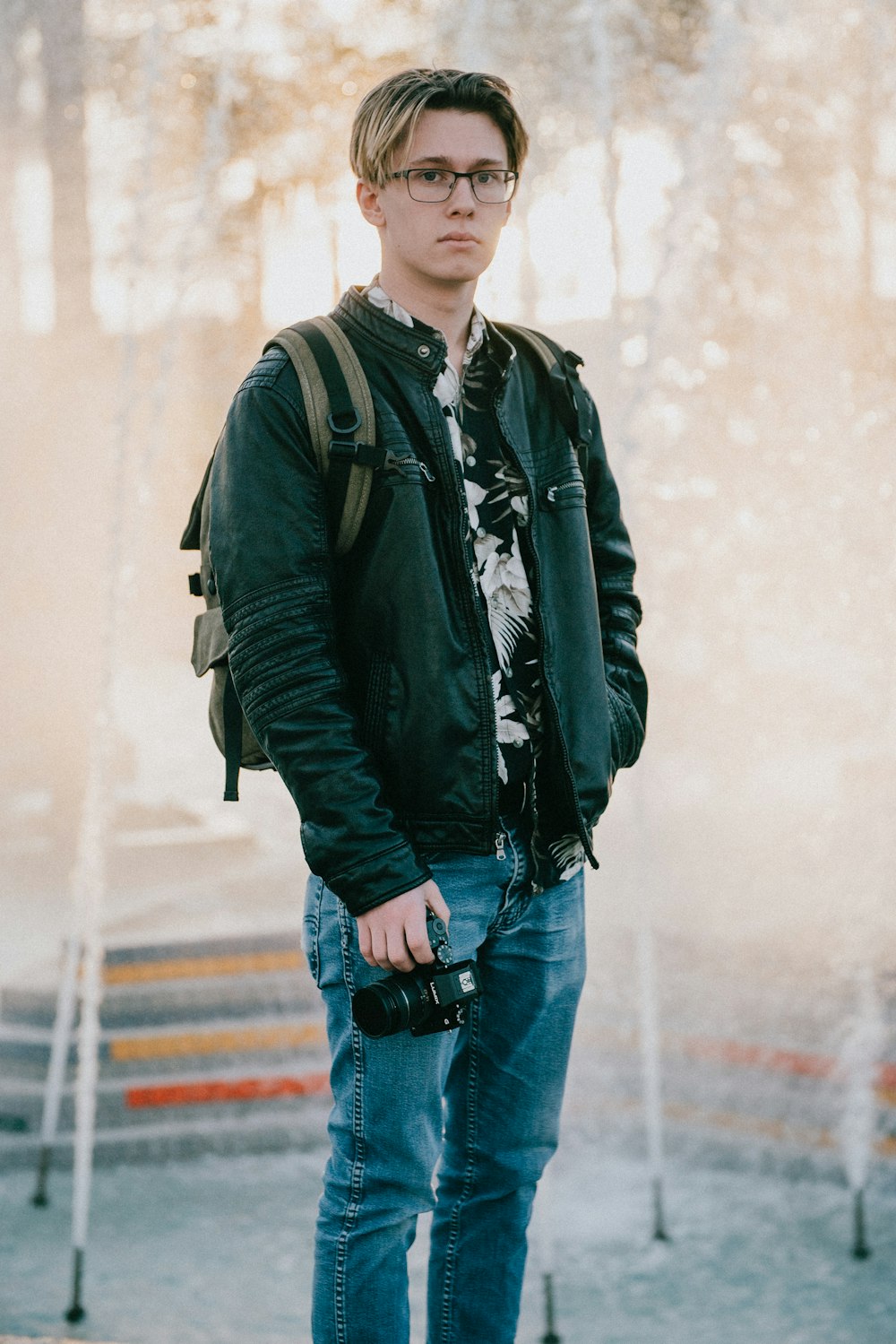 man wearing black jacket and blue denim jeans