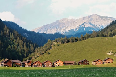 houses surrounded by mountains switzerland teams background