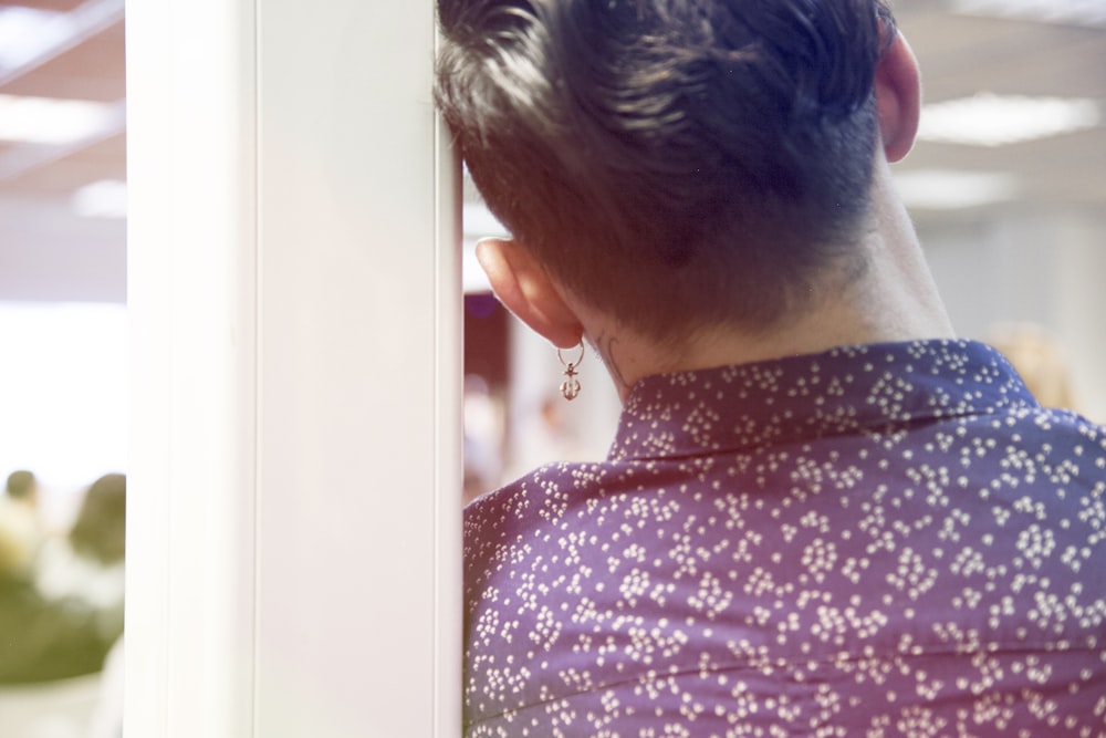 selective focus photography of person wearing blue and white collared top