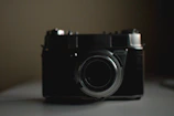 Minimalist artistic shot of a vintage film camera in soft light.