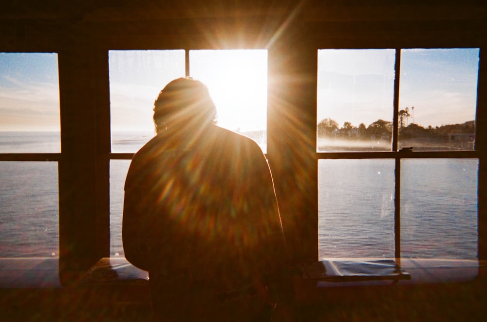 man sitting in front of view window