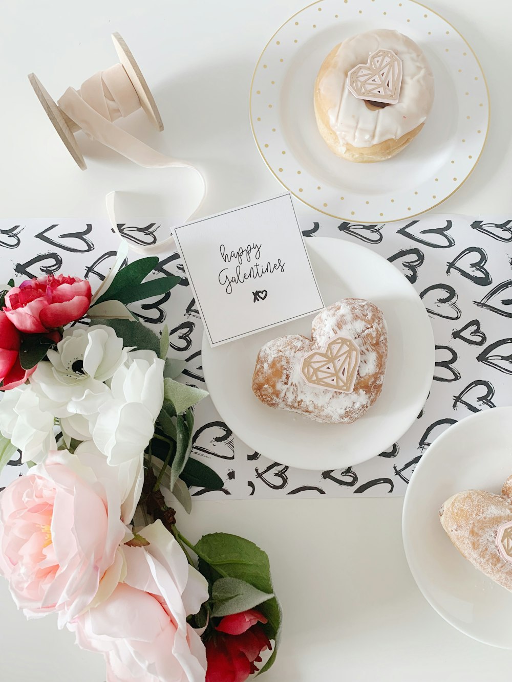 heart doughnut with powdered sugar on white plate