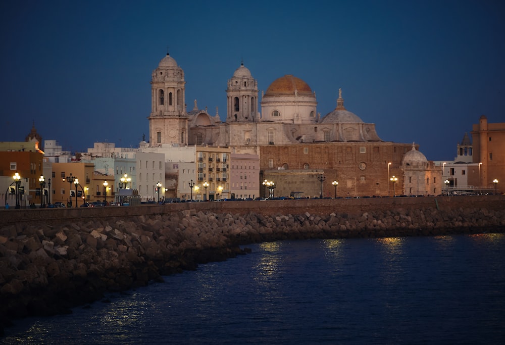 white and brown mosque near body of water