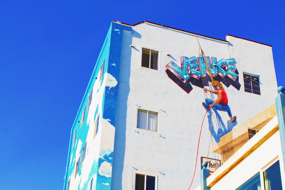 man putting Venice graffiti 3D art on wall