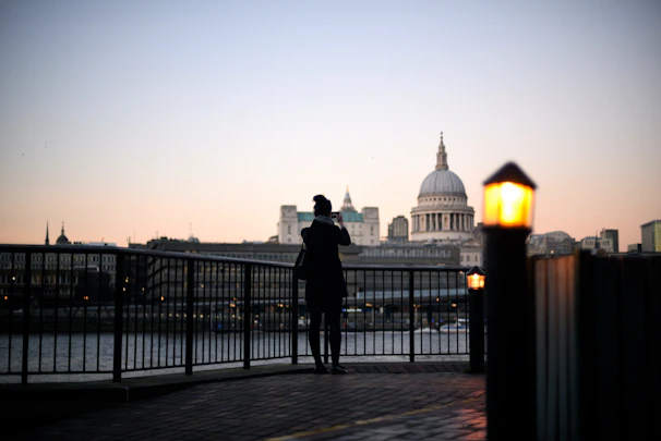 A cinematic still of a couple embracing under soft city lights at dusk.