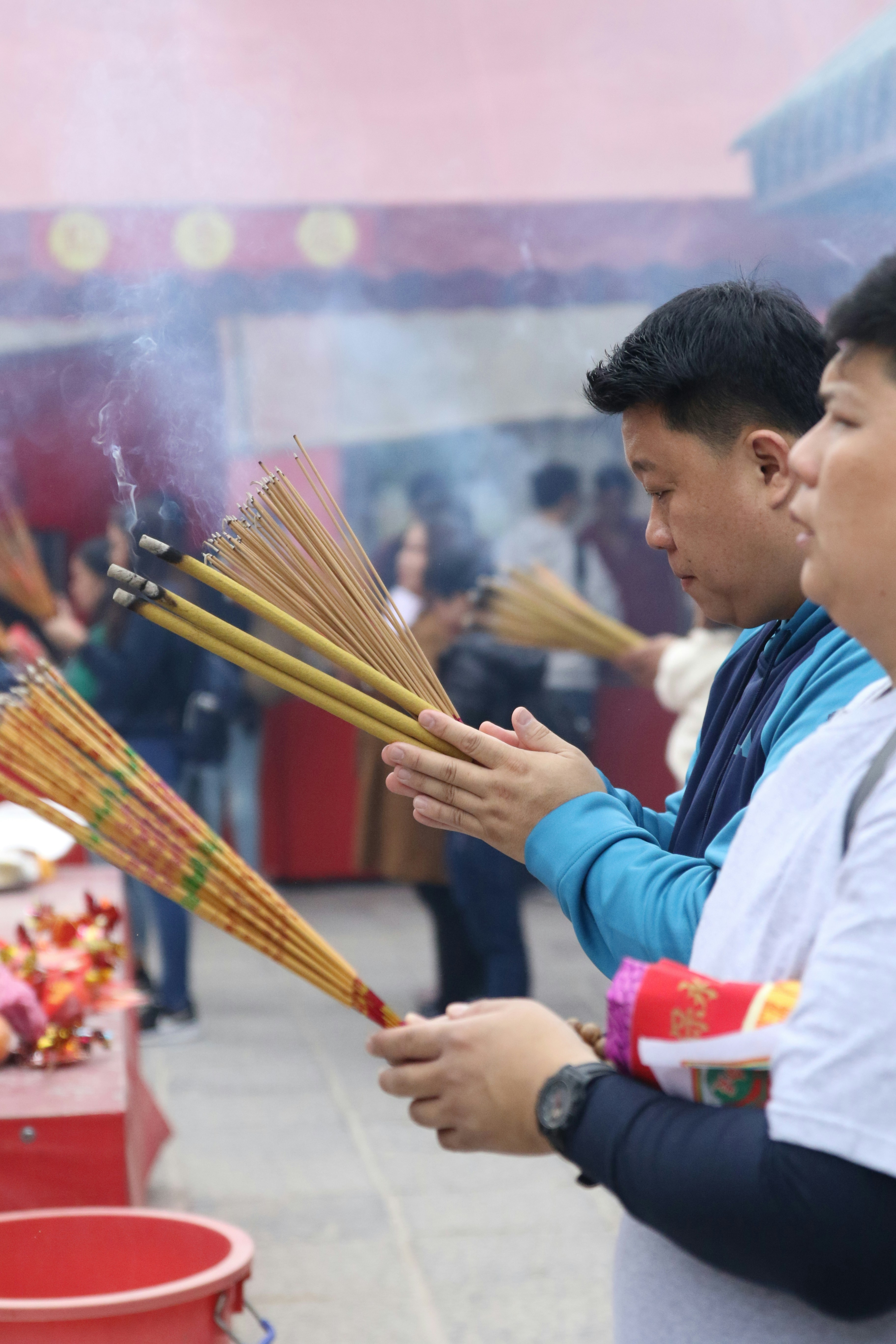 two men holding incense sticks photo Free Person Image on Unsplash