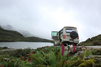 A cozy, well-maintained vehicle parked near a scenic Himalayan backdrop.