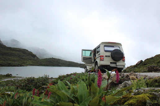 A cozy, well-maintained vehicle parked near a scenic Himalayan backdrop.