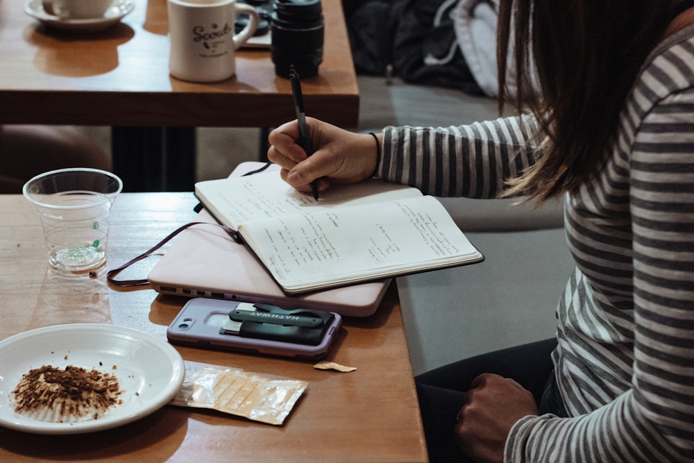 woman writing on notebook