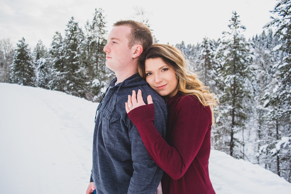 woman hugging man behind his back