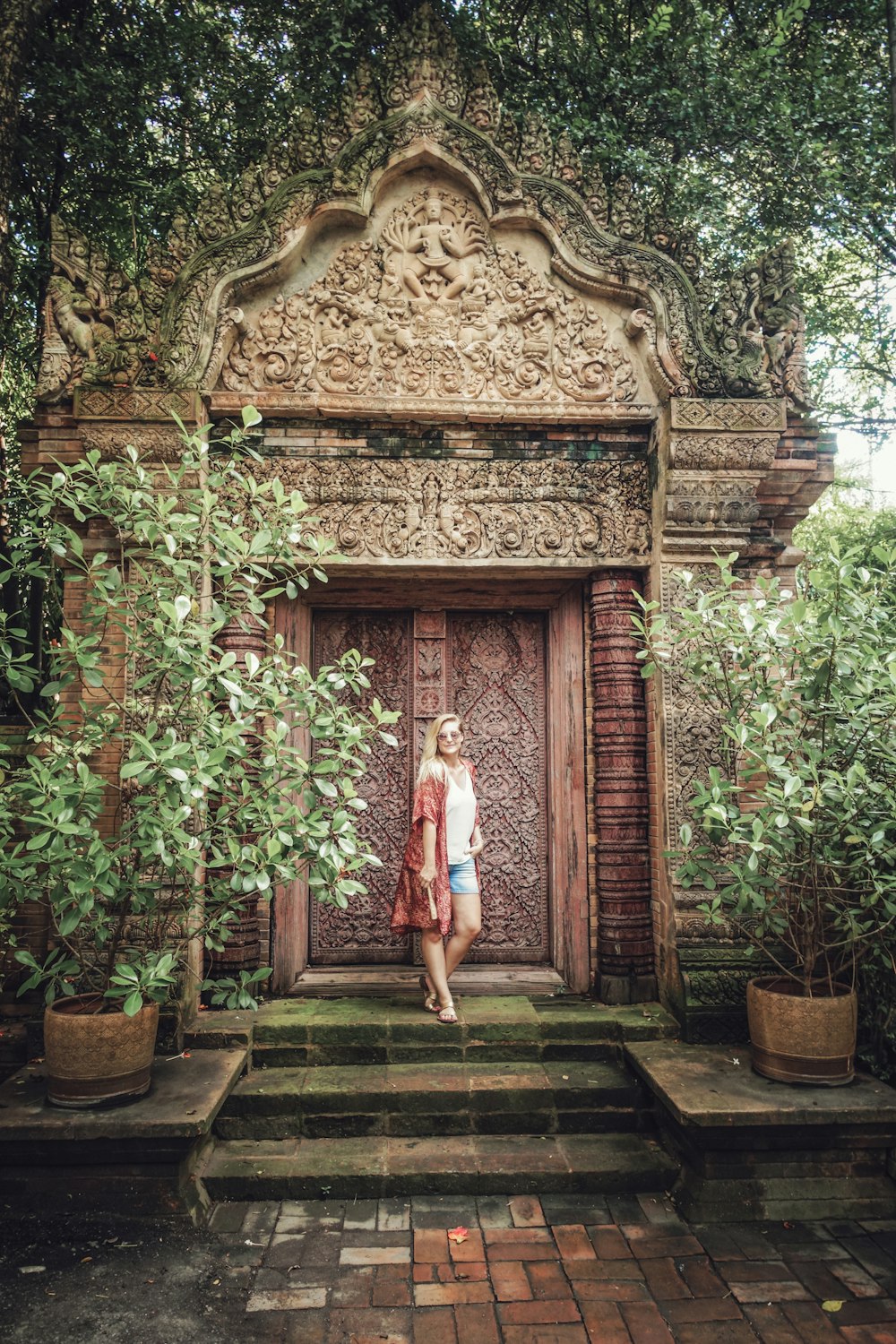 woman standing behind door