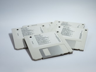 four MacBook diskettes