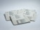 A group of five vintage Macintosh floppy disks arranged in a loose pile on a white surface. Each disk has a label indicating various software titles and installation information. The labels are printed in black text with small Apple logos, and the disks are a light gray color with a metal shutter.