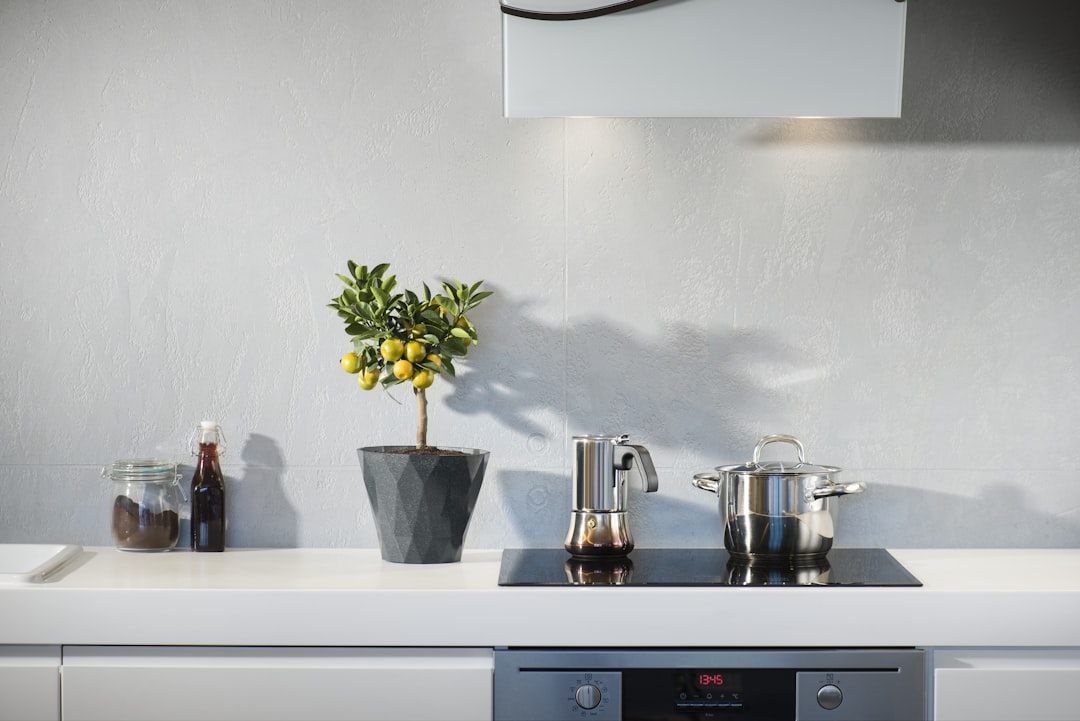  silver pot on top of induction oven pot container utensils