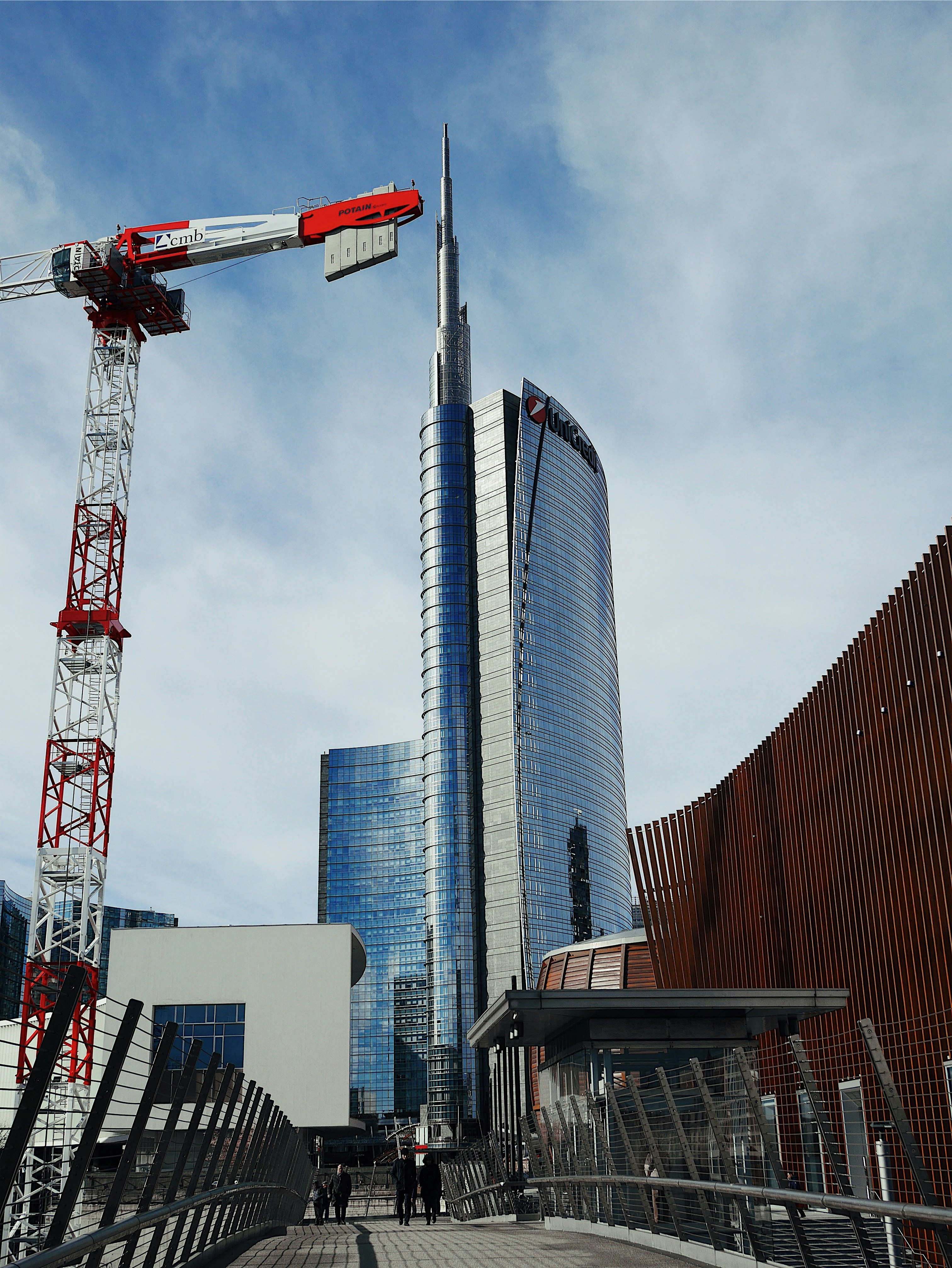 white high-rise building beside tower crane