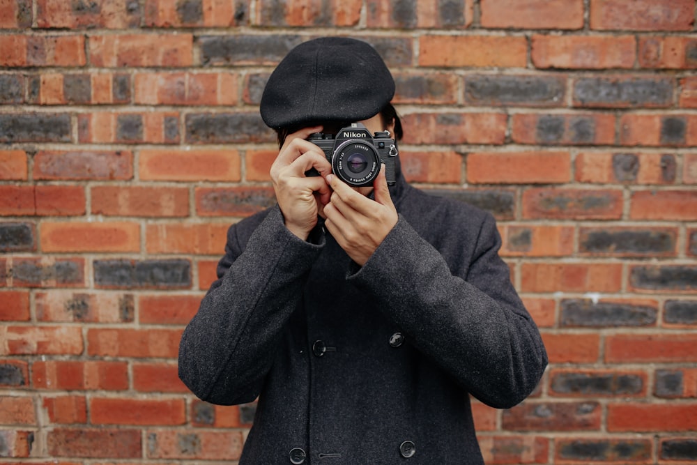 man holding DSLR camera