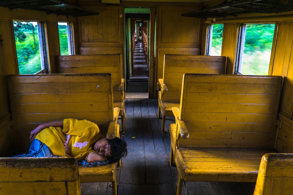 person sleeping inside train during daytime