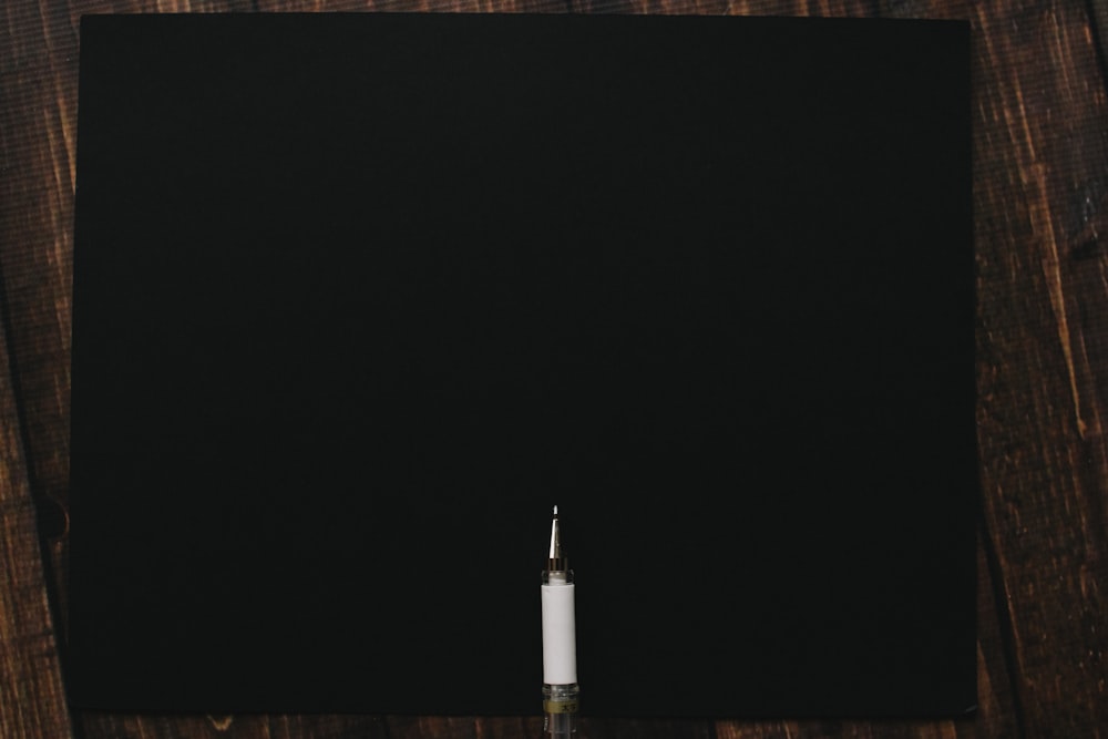 a white candle sitting on top of a wooden table