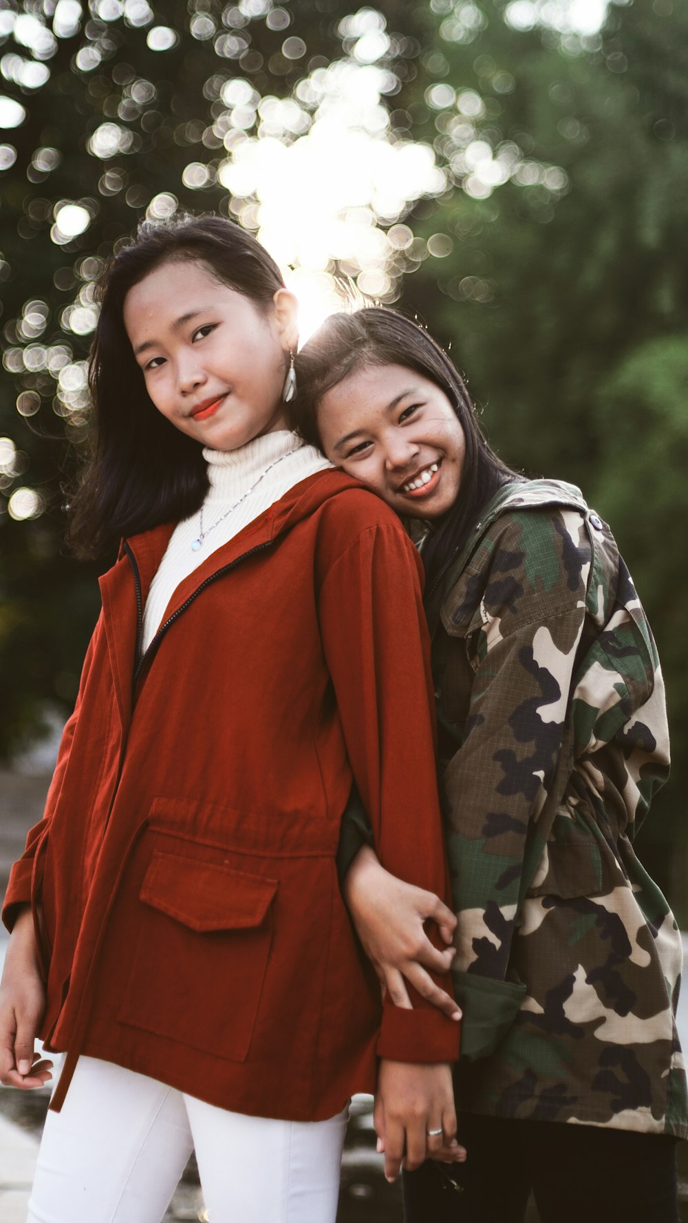 two woman wearing jackets