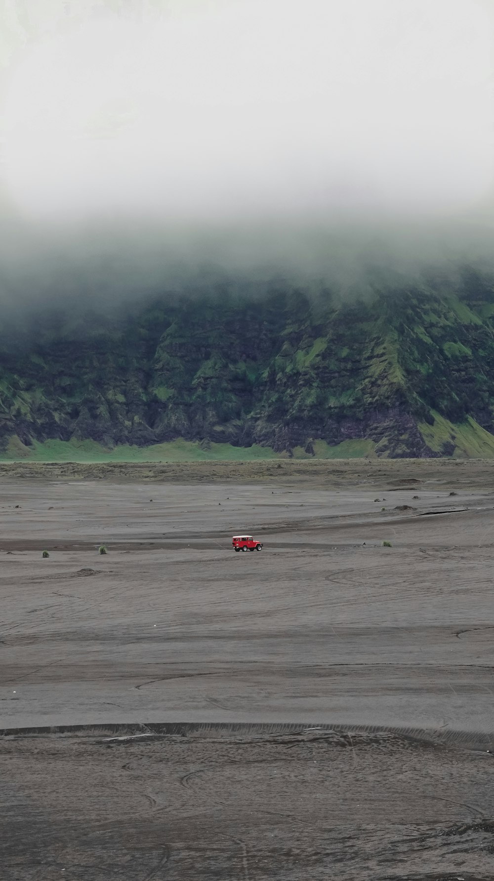 red car in the middle of the field