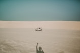 white ATV passing through dunes