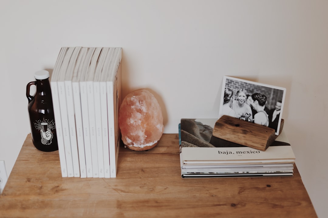 pile of books on brown wooden surface