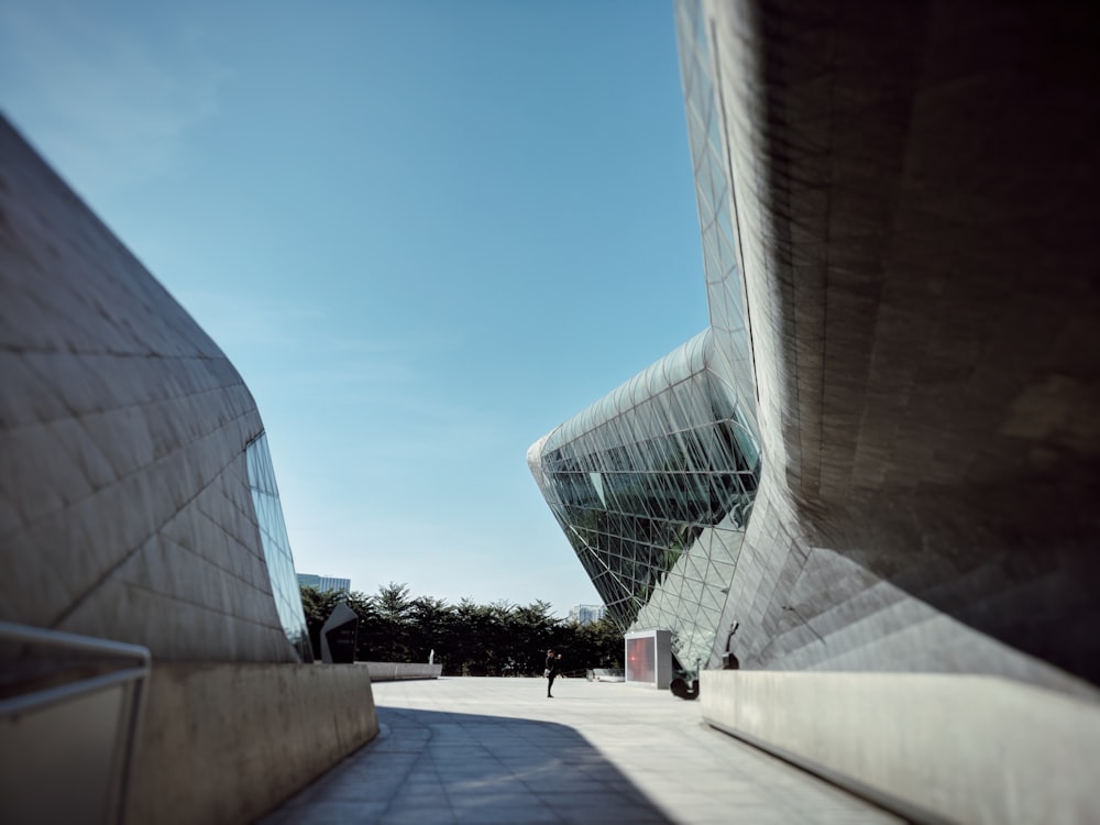 person standing in front of glass building