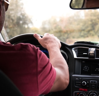 person driving car during daytime