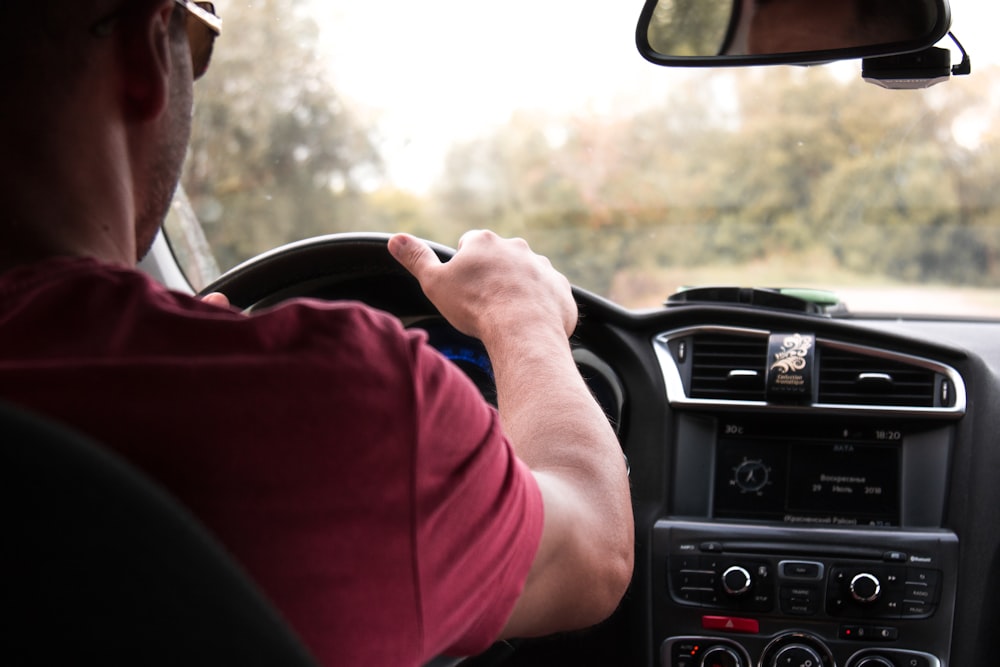 person driving car during daytime