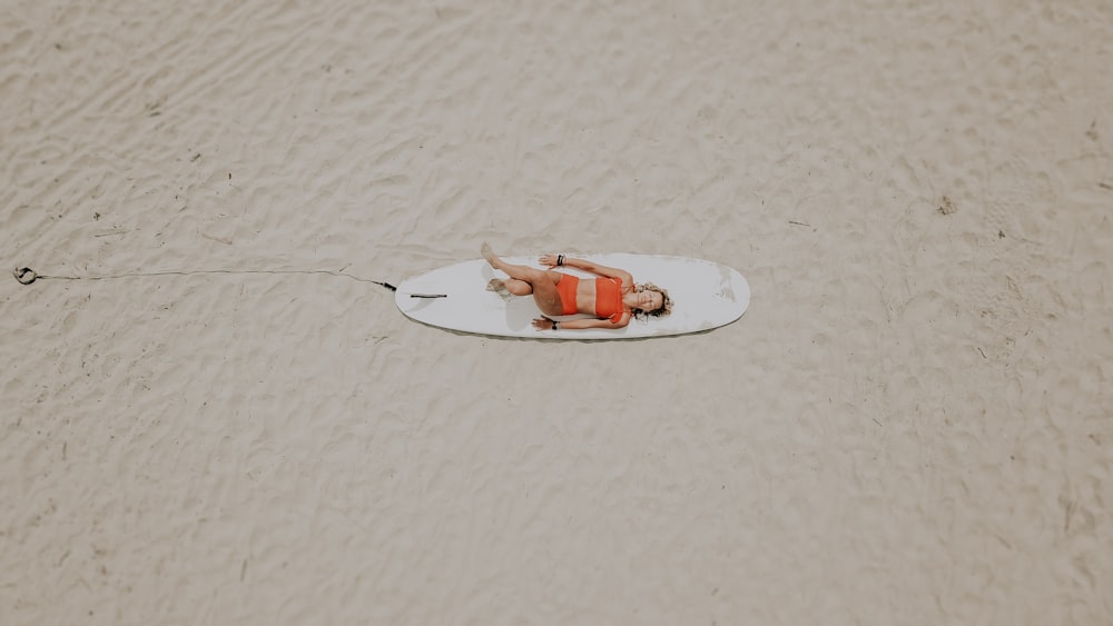 woman on white surfboard