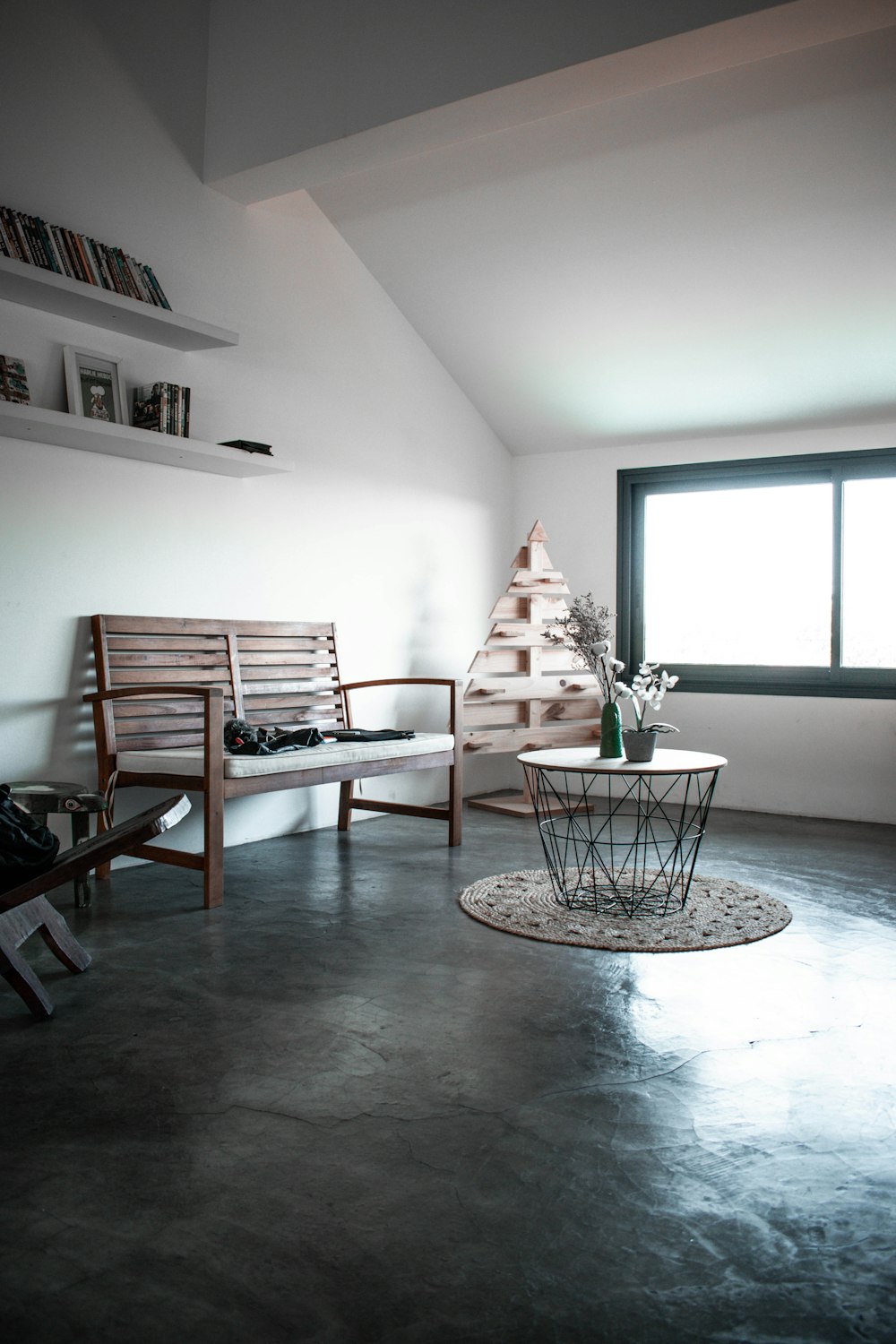 brown wooden danish couch near window