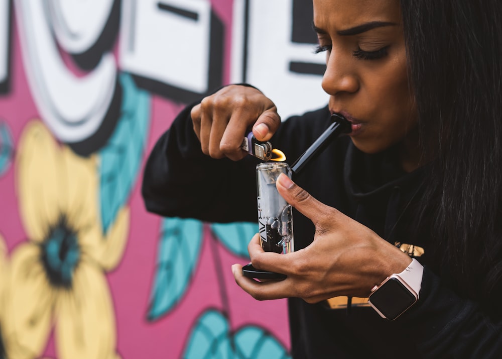 woman holding glass bong