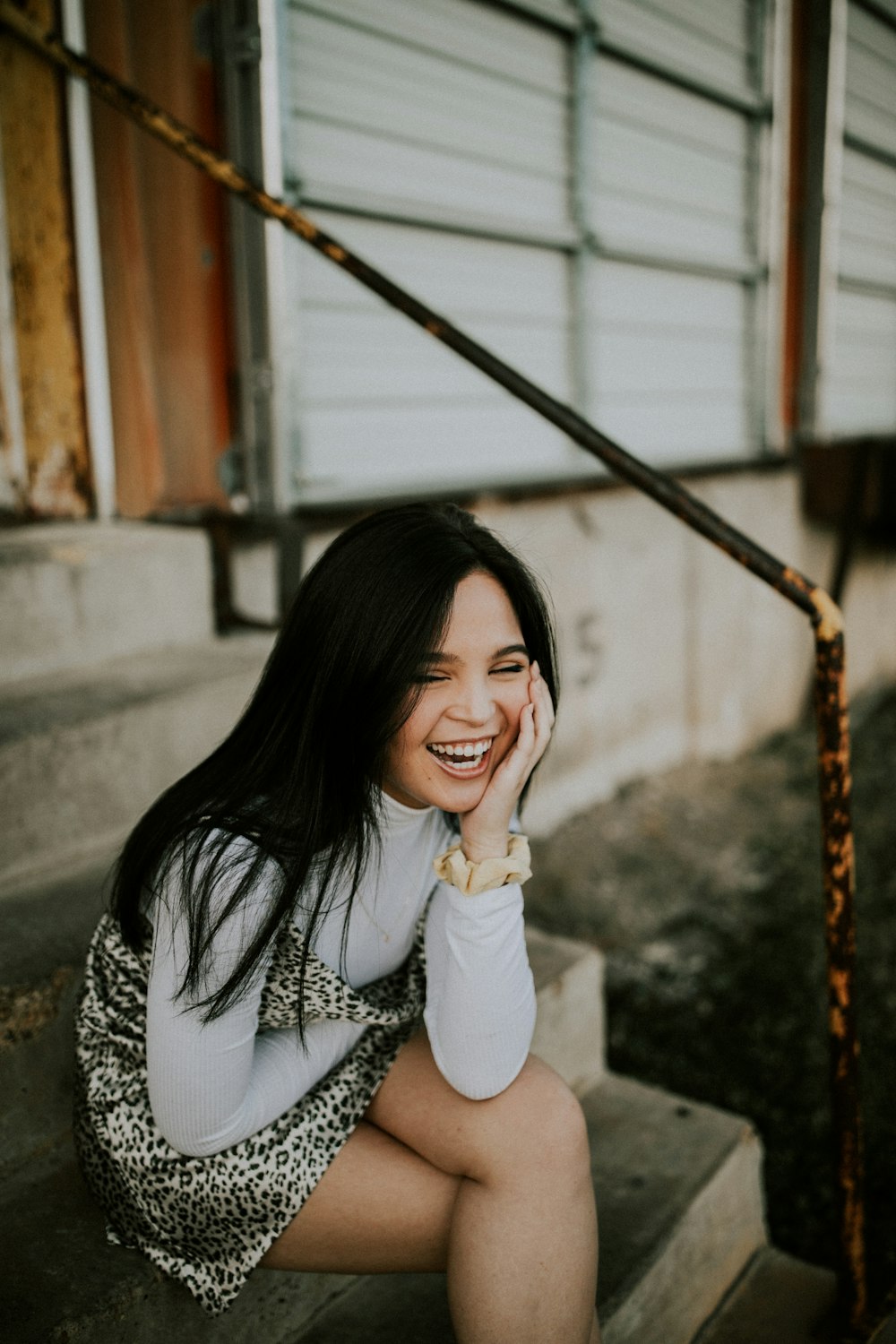 smiling woman sitting on stairs