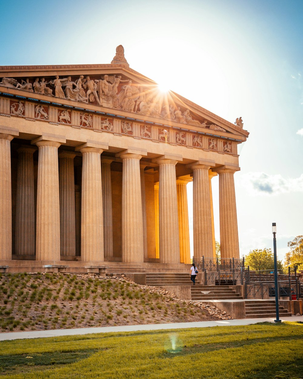 person wearing white top standing near Parthenon