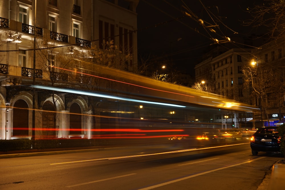 time lapse photo of vehicle passing through sidewalk