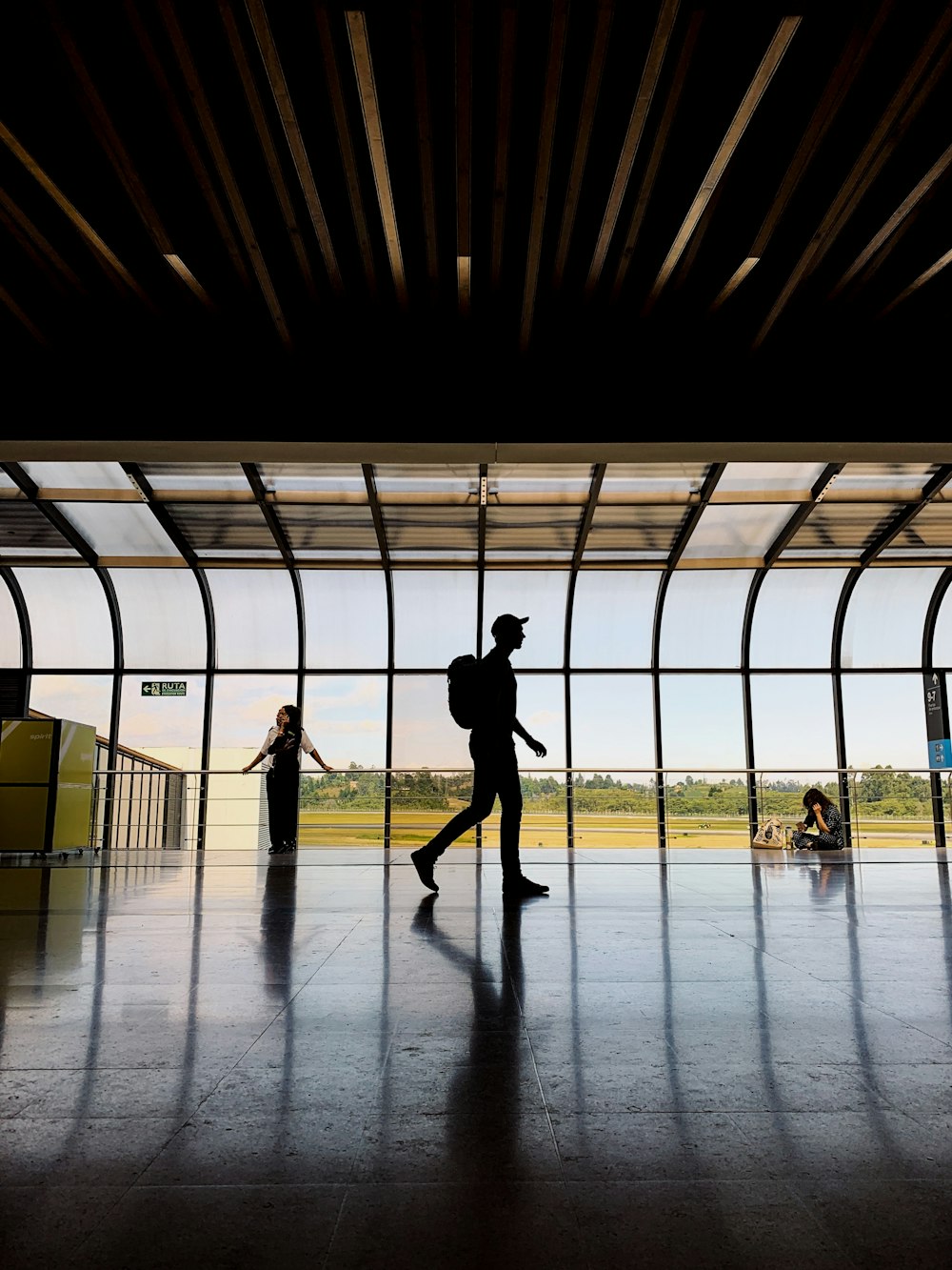 silhouette of man walking in building