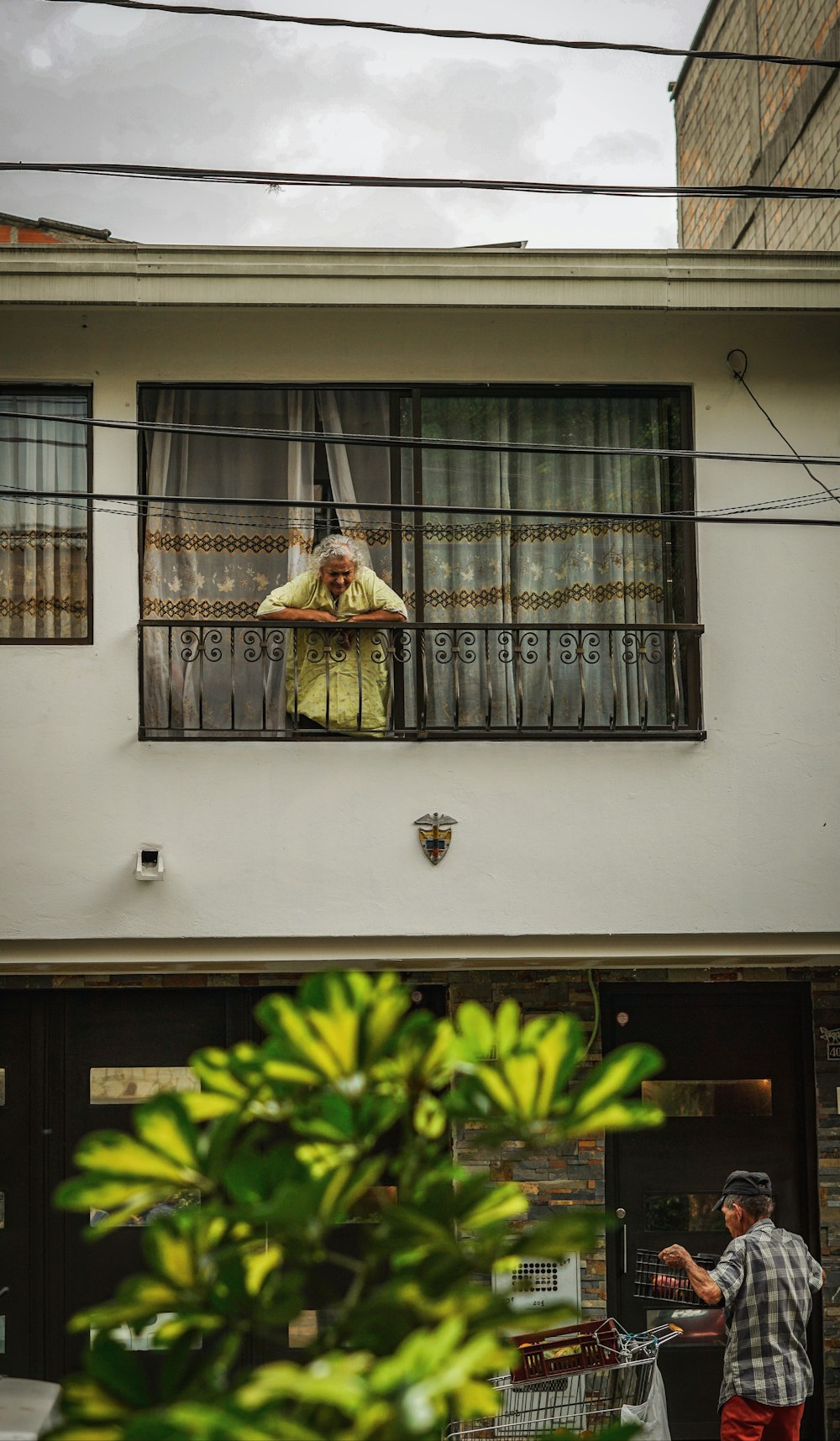 woman leaning on railing on balcony