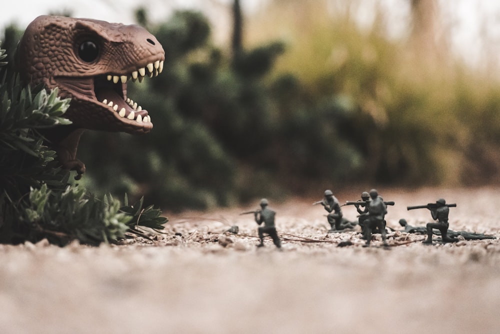 group of soldier near dinosaur miniature