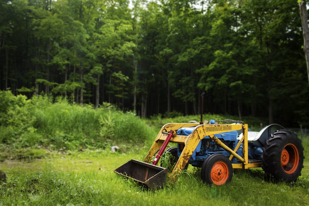 yellow excavator on green grass